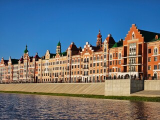 Fototapeta premium Row of buildings with a green roof. The buildings are red and white in Yoshkar-Ola - capital of the Republic of Mari El in Russia
