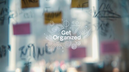 Encouraging text "Get Organized" overlaying a soft-focus office space, used for promoting time management and workflow tips.