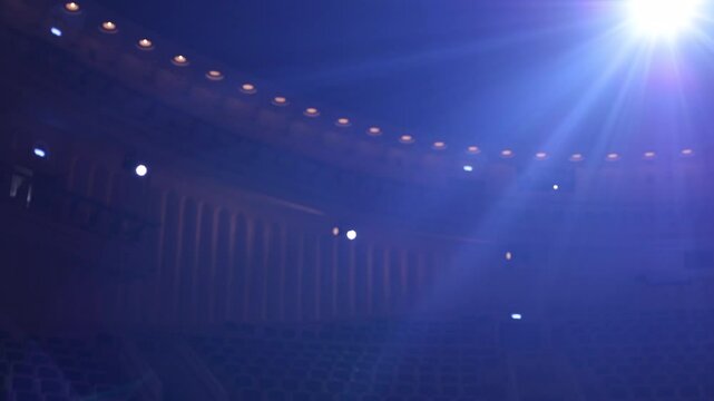 cinematic Projector in a concert hall. Stage blue light with colored spotlights and smoke. Empty theater. Panoramic view on beautiful interior. Moscow Russia 06.20.2025