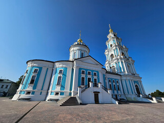 Large blue and white church Epiphany Cathedral in Kostroma with a tall steeple. The building is...