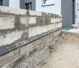 Build a wall around the house with white hollow bricks