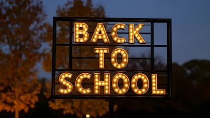 "Back To School" sign glows at dusk, welcoming students. Perfect for education promotions, seasonal campaigns, school events, ads, marketing, and educational content.