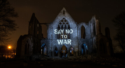 Anti war message projected onto ruined building