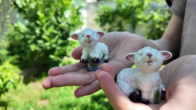 toy lamb. ram figurine. faience lamb figurine. glass toy. vintage figurine. Cute Easter lamb or sheep decoration in young spring grass and ivy,