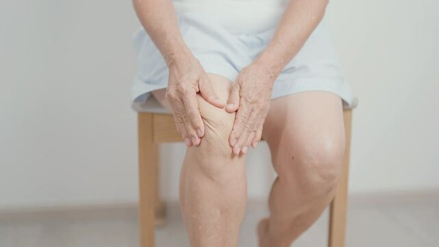 Elderly woman having knee ache and muscle pain due to Runners Knee or Patellofemoral Pain Syndrome, osteoarthritis, arthritis, rheumatism and Patellar Tendinitis. Senior health and medical concept