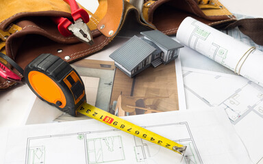 Model of a family house on a blueprint.