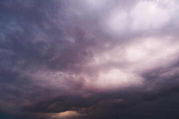 Dramatic thunderstorm with dark clouds in the evening. Dramatic cloudscape featuring dark, moody...