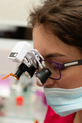 Focused examination in a modern laboratory setting showcasing advanced magnification tools,...