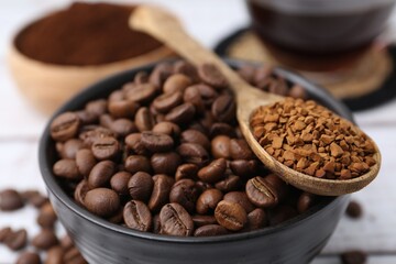 Roasted beans and granulated instant coffee on light table, closeup