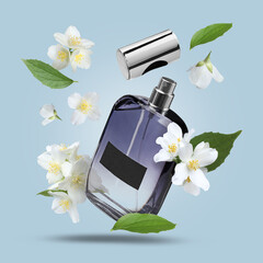 Bottle of floral perfume and jasmine flowers in air on light blue background