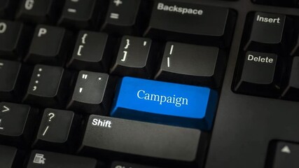 Keyboard with blue campaign button key close-up
