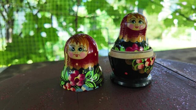 wooden matryoshka doll. Hand Holding a Wooden Matryoshka Doll &ndash; Traditional Russian Nesting Doll. Collection of traditional Russian nesting dolls. Beautiful handmade matryoshka dolls in a row.