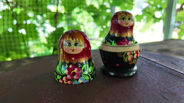 wooden matryoshka doll. Hand Holding a Wooden Matryoshka Doll &ndash; Traditional Russian Nesting Doll. Collection of traditional Russian nesting dolls. Beautiful handmade matryoshka dolls in a row.