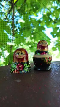 wooden matryoshka doll. Hand Holding a Wooden Matryoshka Doll &ndash; Traditional Russian Nesting Doll. Collection of traditional Russian nesting dolls. Beautiful handmade matryoshka dolls in a row.