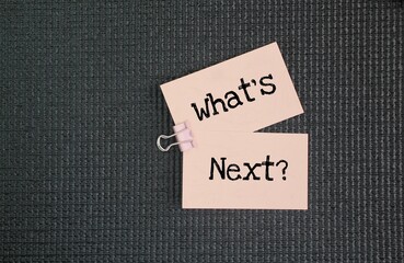 Paper with the word question What's Next? next step concept. coming immediately after the time of...
