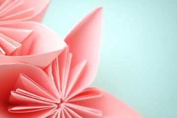 Delicate Coral Origami Flowers on Mint Background: Close-up Abstract Art