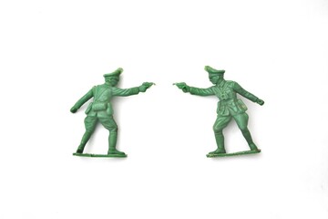 Green Plastic Toy Soldiers Duel on White Background, Childhood Nostalgia