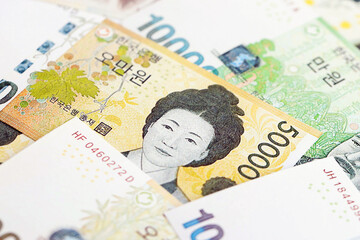 South Korean won money bills in big amount lies on white color table close up