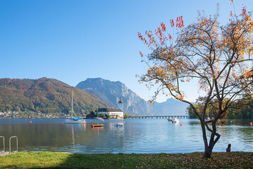 autumnal scenery at lake shore Traunsee, view to Ort castle, austria
