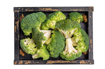 Green raw broccoli pieces in a wooden tray isolated on white background. top view