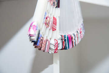 A palette of nail designs of different colors with gel polish on a white background. A collection...