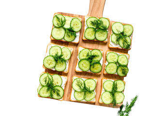 Cucumber Sandwiches with Dill on Wooden Board – Top View

