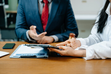 business people and lawyers discussing contract papers sitting at the table. Concepts of law,...
