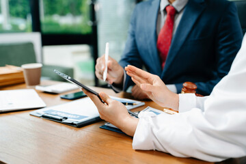 business people and lawyers discussing contract papers sitting at the table. Concepts of law,...