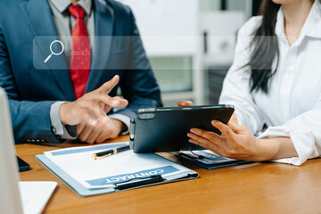 Lawyer and client discussing a legal contract using a digital tablet with a search interface overlay