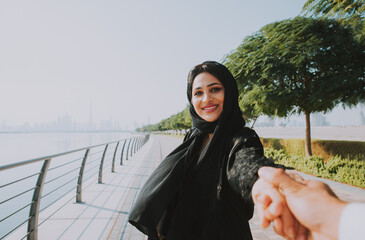 Happy couple walking in Dubai. Man and woman going out for shopping. Concept about relationship in...