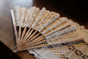 A Lace Material Ladies Fan with Wooden Stays.