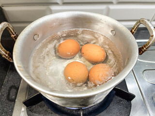 Eggs Boiling in Aluminum Pot on Gas Stove Kitchen Cooking Process