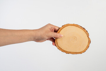 Wooden coaster for drinking water or props for taking photos in hand with a white background
