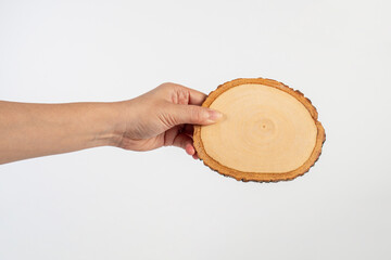 Wooden coaster for drinking water or props for taking photos in hand with a white background
