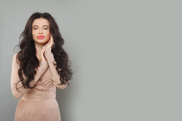 Fashionable model woman posing on gray background, fashion portrait