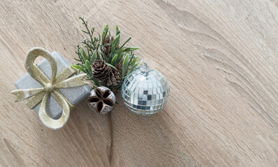 Christmas tree miniature, candle and pine cone on wooden board, mini tabletop decor. Christmas web...