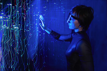 Woman using cyber glasses in a virtual reality simulator with neon lights