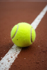 Vibrant Tennis Ball on Clay Court