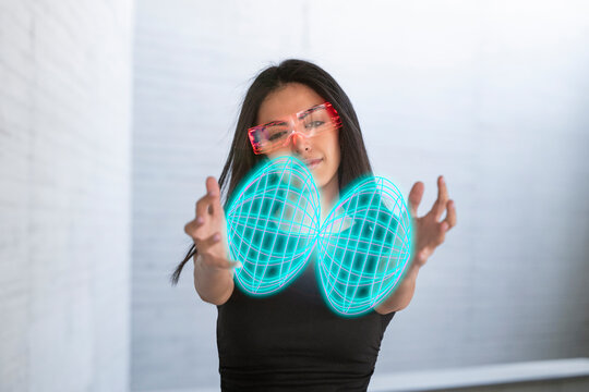 Woman using AR glasses to interact with a virtual hologram