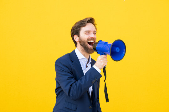 Businessman with a megaphone against a yellow background