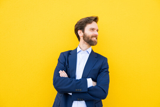 Red-haired businessman smiling against yellow background