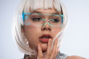 Close up of futuristic woman in holographic smart glasses