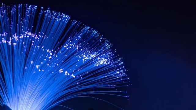 Illuminating the core of innovation, a radiant spectacle of fiber optics unveils a vibrant interplay of light and connectivity. The photograph, a symphony of blues. - Powered by Adobe