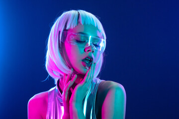 Futuristic woman in neon light with holographic smart glasses