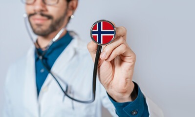 Doctor holding stethoscope with Norway flag. Norway health and care concept, Norway flag on stethoscope