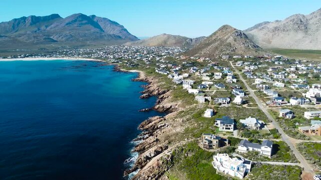 Camera moving sideways over the small town of Pringle Bay, 4K aerial video
