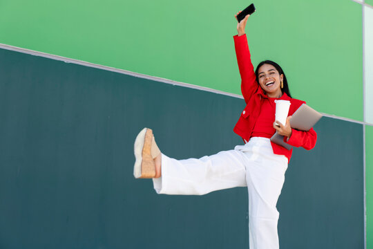 Cheerful female professional celebrating outdoors