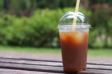 Bumble coffee. Coffee with juice in a disposable plastic cup with a straw. Coffee with orange...