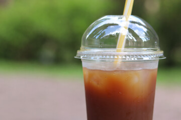Bumble coffee. Coffee with juice in a disposable plastic cup with a straw. Coffee with orange...