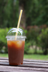 Bumble coffee. Coffee with juice in a disposable plastic cup with a straw. Coffee with orange...